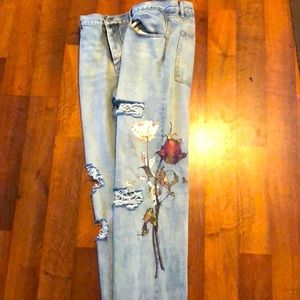 Blue jeans with wilted rose print on the side